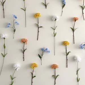 How To Make Your Own DIY Flower Wall Fake Flowers For Wall, Washi Tape Flower Wall, Tape Flowers To Wall, Flower Decoration Bedroom, Floral Background Diy Backdrop Ideas, Dorm Flower Wall, Taped Flower Wall, Upside Down Flower Wall, Live Flower Wall