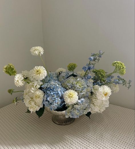 White and blue hydrangea compote with white dahlias Hydrangea White Centerpiece, Blue Hydrangeas Centerpiece, Blue White Centerpieces, Hydrangea And Dahlia Bouquet, Blue And White Party Aesthetic, Blue And White Arrangements, Blue Baby Shower Flowers, Hydrangea Table Centerpiece, Blue Hydrangea Arrangements