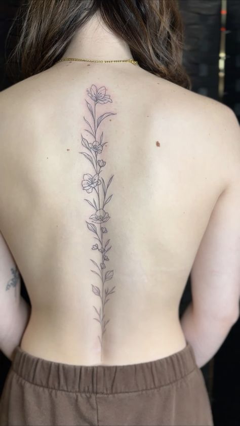 Tulips Spine Tattoo, Spine Tattoos For Women Unique Simple, Fine Line Back Tattoo Women Spine, Spine Tattoo Drawings, Wild Flower Spine Tattoo, Lilly Spine Tattoo, Dainty Flower Spine Tattoo, Leaf Spine Tattoo, Tulip Spine Tattoo