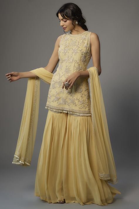 Featuring a yellow kurta in georgette base with pearl, cutdana, and seep work. It is paired with matching sharara pants and a net dupatta. . #perniaspopupshop #whatiworewastrending #ppuslove #malasa #sharara Net Sharara Designs, Elegant Yellow Sharara For Festivals, Sharara Yellow Colour, Sharara Ideas, Yellow Garara Dress, Yellow Semi-stitched Georgette Sharara, Yellow Georgette Sharara With Sheer Dupatta, Yellow Garara, Sharara Suit Wedding