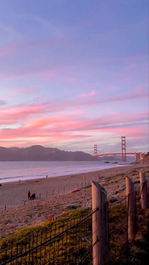 A sunset at the beach with Golden Gate Bridge in the background San Francisco Sunset, San Francisco Wallpaper, Presidio San Francisco, Pastel Nature, Sf Wallpaper, California Coast Road Trip, San Francisco Travel, Sunset Wallpaper, California Dreamin'