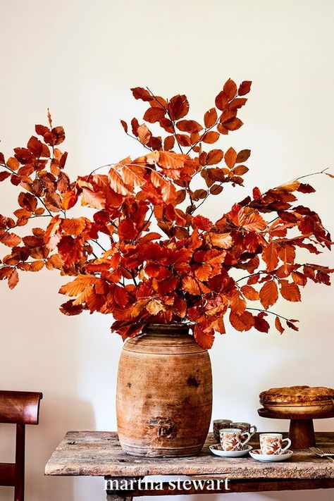 A burst of bright dried branches is simpler and more seasonal than flowers, and it'll never wilt or need water. Just arrange preserved beech leaves in a big vase (days in advance), and let their burnt tones light up your dining table throughout fall and for your Thanksgiving meal. #marthastewart #diydecor #diyprojects #diyideas #hobby Fall Dining Table, Vase With Branches, Romantic Bedroom Decor, Autumn Dining, Big Vases, Fall Flower Arrangements, Fall Floral Arrangements, Fall Arrangements, Branch Decor