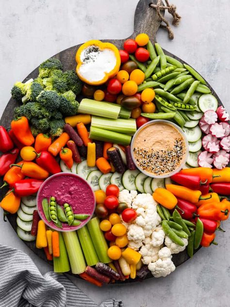 Every get-together needs a nutritious veggie charcuterie board full of colorful vegetables beautifully displayed all together. Perfect as an appetizer or side dish, this healthy board of fresh veggies is a hit served with a side of hummus and ranch dressing. Charcuterie Board Ideas Vegetables, Cheese Veggie Platter, Charcuterie Board With Vegetables, Plate Of Vegetables, Fresh Fruits And Vegetables Appetizer, Veggie And Dip Charcuterie Board, Veggie And Dip Board, Veggie And Fruit Board, Vegetable Grazing Board