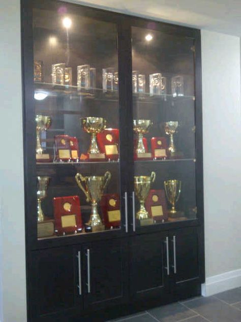 Our Trophy Showcase at the office Award Shelves, Trophy Display Shelves, Trophy Cabinets, Shoe Storage Design, Trophy Display Case, Wall Display Case, Modern Tv Room, Glass Cupboard, Cabinet Glass Doors