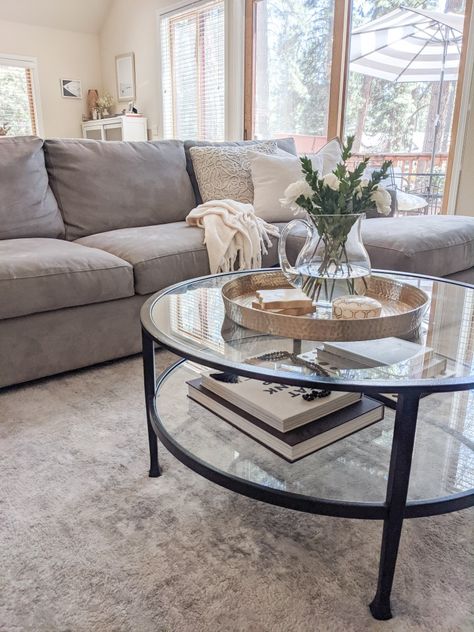 Coffee Table With Grey Sectional, Black Glass Coffee Table Living Room, Circle Glass Coffee Table Decor, Grey Couch With Coffee Table, Black Couch Coffee Table, Black Glass Table Living Rooms, Glass Table Living Room Decor, Grey Couch Coffee Table Ideas, How To Style Glass Coffee Table