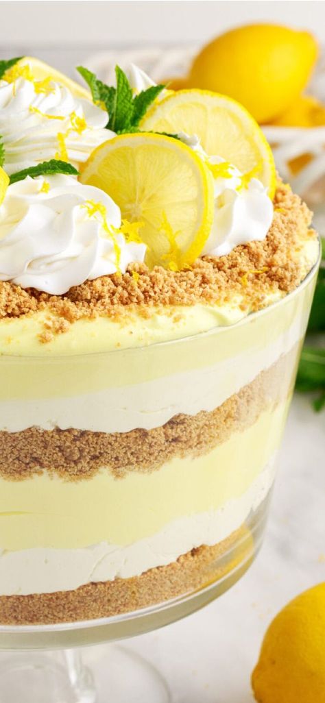 Lemon lush trifle is fluffy, light, and airy - perfect for summer potlucks and parties! #amandascookin #triflerecipes #easydesserts Lemon Lush Trifle, Summer Trifle Desserts Easy, Summer Trifle Desserts, Lemon Trifle, Lemon Lush Dessert, Trifle Bowl Recipes, Trifle Dessert Recipes, Finger Desserts, Lemon Lush