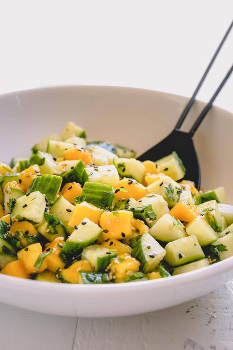 Mixed with flavorful Asian dressing, this light and refreshing cucumber mango salad is the perfect side for grilled meats and roasted salmon. Mango Cucumber Salad, Cucumber Salad Dressing, Cucumber Mango, Asian Dressing, Cucumber Salad Recipe, Cucumber Diet, Grilled Meats, Grape Salad, Resep Diet