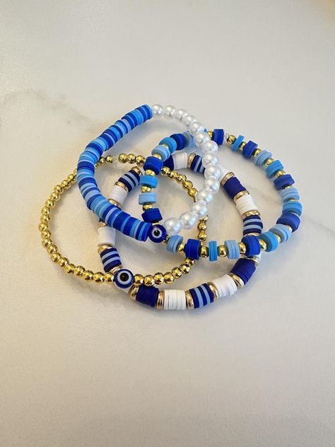 Blue and gold clay bead bracelet collection. Navy Blue Clay Bead Bracelets, Star Clay Bead Bracelet, Fun Clay Bead Bracelet Ideas, Dark Blue Clay Bead Bracelet, Bracelet Ideas Clay Beads Aesthetic, Cool Clay Bead Bracelet Ideas, Clay Bracelet Idea, Clay Bead Brackets, Blue Clay Bead Bracelets