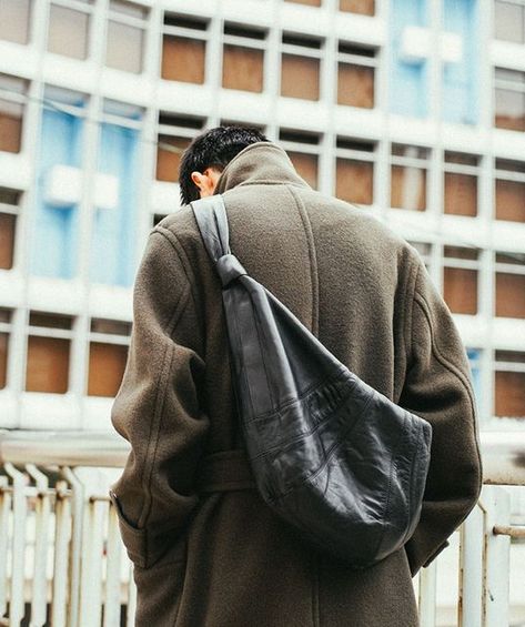 Lemaire on Instagram: "The iconic Croissant bag hugs its wearer, becoming an extension of garments and the body. Pictured here in dark chocolate, worn across the shoulder with the wrap coat, the soft full-grain leather bag is designed for easy, casual wear and effortless pairings. #LEMAIRE" Lemaire Croissant Bag, Croissant Bag, Full Grain Leather Bag, Mens Bags Fashion, Wrap Coat, Bags Aesthetic, Bag Boys, Mens Leather Bag, Coat Outfits