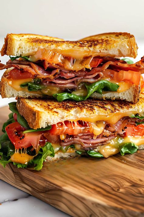 This BLT grilled cheese sandwich features crispy bacon, gooey melted cheese, juicy tomatoes, and fresh lettuce, all nestled between buttery grilled sourdough. Pack Sandwich For Lunch, Best Sandwiches Ever, Grilled Sourdough Sandwiches, Gourmet Blt Sandwich, Farm Lunch Ideas, Sourdough Grilled Cheese Sandwiches, Manly Sandwiches, Stuff To Grill, Ham Grilled Cheese Sandwich