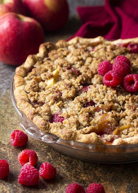 My homemade apple raspberry pie is the best! It's packed full of sliced apples and fresh, sweet raspberries then covered with a buttery streusel crumb topping. Perfect for holidays, Christmas, and Thanksgiving. | justalittlebitofbacon.com #christmasrecipes #thanksgivingrecipes #holidayrecipes #dessertrecipes #applepie #raspberrypie #pie Apple Raspberry Pie Recipes, Raspberry Pie With Crumb Topping, Raspberry Apple Pie, Apple Raspberry Pie, Raspberry Crumble Pie, Crumb Top Apple Pie Recipe, Apple Crumb Pie Recipe, Deep Dish Apple Pie, Apple Crumb Pie