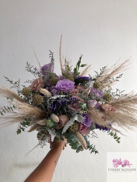 CBR680 Weddings at the beach , soft romantic bridal bouquet with pampas grass lilas and purple Flowers at Tulum Riviera Maya and Playa del Carmen Mexico by Cherry Blossom  #bridalbouquet #pampasgrassbouquet Lavender Boho Wedding Decor, Purple And Pampas Grass Wedding, Boho Purple Bouquet, Boho Wedding Bouquet Purple, Pampas Grass And Lavender Wedding, Lavender And Pampas Wedding, Purple Pampas Grass Bouquet, Purple Wild Flower Bouquet, Purple Boho Wedding Decor