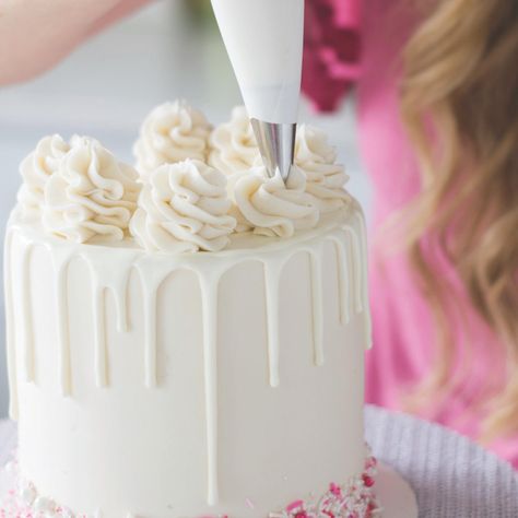 So This Is How You Decorate a Cake Like a Pro | Brit + Co Perfect Drip Cake, Candy Melt Drip Cake, Rosette Drip Cake, Icing Swirls On Cake, How To Make Swirls On Cake, Drip Icing Recipes Easy, How To Make A Drip Cake Step By Step, Candy Melt Drip Recipe, Cake Dripping Icing How To Make