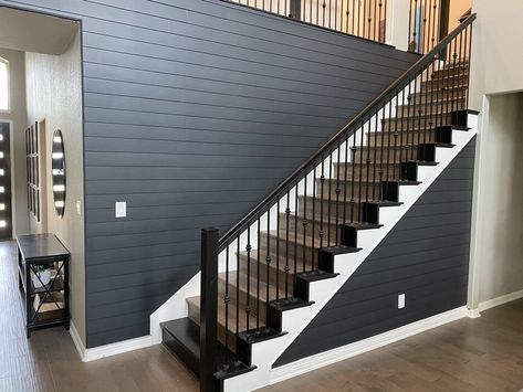 Shiplap takes a dark turn with this black shiplap staircase. Stair Shiplap Wall, Shiplap Up Staircase, Dark Shiplap Entryway, Black Shiplap Staircase Wall, Black Shiplap Stairwell, Black Shiplap Wall Entryway, Iron Ore Staircase Wall, Black And Wood Staircase Modern, Staircase Shiplap Wall