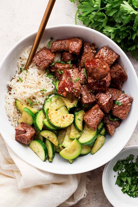 Garlic Butter Steak Bites - A delicious and easy Garlic Butter Steak Bites recipe that is packed with flavor and comes together in just 30 minutes! #garlicbuttersteakbites #garlicbuttersteakbitesrecipe #garlicbuttersteakbiteswithzucchini #steakbiteswithgarlicbutter Dinner Ideas For Two Summer, Healthy Steak Tip Recipes, Easy Healthy Steak Recipes, Easy Meals With Steak, Healthy Recipes Steak, Balanced Lunches For Work, Steak Tips Meal Prep, Easy Steak And Rice Recipes, Steak Zucchini Recipes