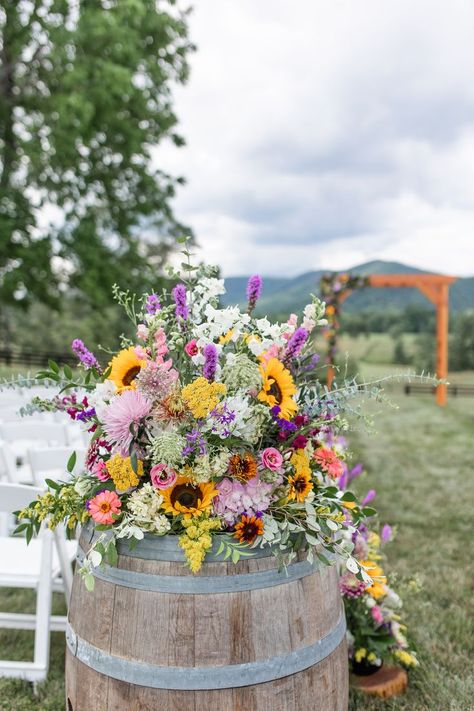 Floral Arrangement on Wine Barrel for Ceremony Wedding Aisle Summer Rustic Centerpieces, Wildflower Wedding Outdoor, Wedding Tablescapes Wildflowers, Wild Flower Centre Piece Wedding, Roses And Wildflower Bouquet, Boho Wildflower Wedding Decor, Wildflower And Sage Wedding, Wildflower And Eucalyptus Wedding, Rustic Wedding Decor Wildflowers