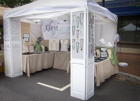 Hide poles and display with large window screens & vintage shutters #visualmerchandising #storedisplay Vendor Booth Display, Craft Fair Booth Display, Jewelry Booth, Craft Show Booths, Vintage Shutters, Craft Show Booth, Craft Booth Display, Jewerly Displays, Craft Fairs Booth