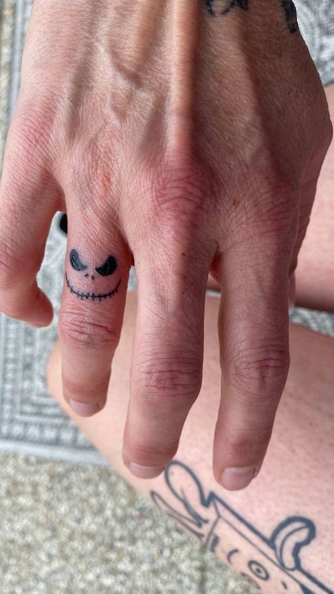 Jack Skellington tattoo finger Jack Skellington Finger Tattoo, Men's Small Tattoo Hand, Mens Tatoos Ideas Hand, Jack And Sally Finger Tattoo, Cute Small Tattoos For Men, Tattoos On Fingers Men, Tatoos Men Hand Small Simple, Cool Small Tattoos For Men Simple, Small Tattoo Ideas On Fingers