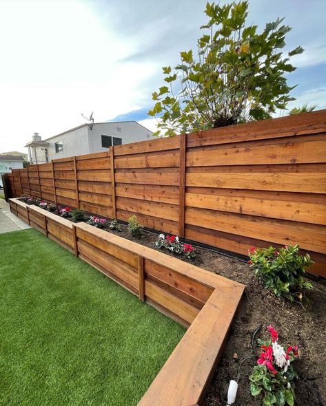 Built planter boxes along the fence line to create a beautiful and functional garden space. The planter boxes will not only add visual appeal to the fence line but also provide an opportunity to grow a variety of flowers. Planter boxes from @glscapes Backyard Raised Planter Ideas Along Fence, Flower Box Along Fence, Long Flower Boxes Planters, Backyard Planter Boxes Along Fence, Fence With Garden Boxes, Planter Boxes On House, Back Fence Garden Ideas, Planter Along Fence Line, Fence With Hanging Plants