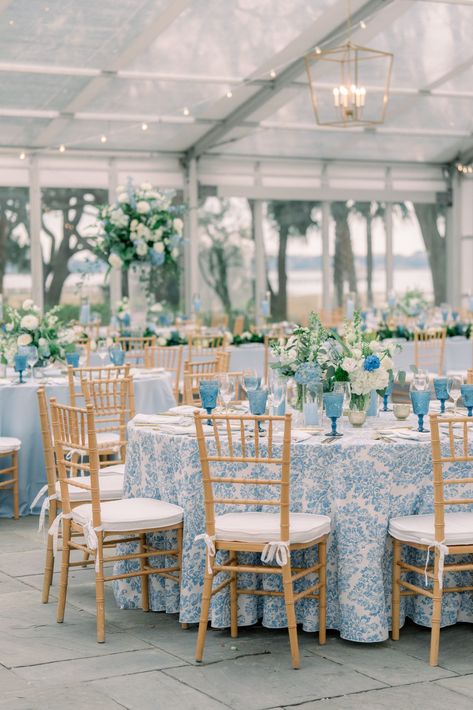 Blue floral table linens with tan chiavari chairs. Blue and white flowers. Navy And Carolina Blue Wedding, Blue And White Tablecloth Wedding, Blue And Rattan Wedding, Classic Blue Wedding Theme, Blue Navy Wedding Theme, Blues And White Wedding, Timeless Coastal Wedding, Blue December Wedding, Blue And White Toile Wedding