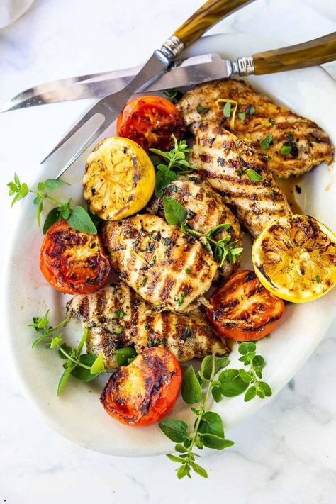 How to make the Best Grilled Chicken- flavorful and juicy every single time! A simple, easy recipe made with chicken breast, garlic, herbs and lemon! #grilledchicken Grilled Lemon Herb Chicken, Chicken With Roasted Vegetables, Chicken With Herbs, Grilled Lemon Chicken, Feasting At Home, Grilled Lemon, Lemon Herb Chicken, Herb Chicken, Lemon Herb