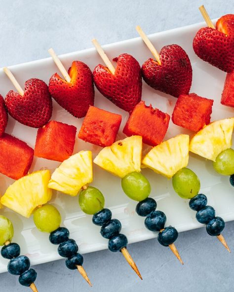 Fruit skewers are a fun and festive appetizer or snack! This healthy treat is easy to make and pleases everyone. #fruitskewers #fruit #skewers #appetizer #easyappetizer #snack #healthysnack #summerappetizer Skewer Fruit Ideas, Berry Skewers Sticks, Fruit Screwers Food Ideas, Bridal Shower Fruit Skewers, Mini Fruit Kabobs For Party, Fruit Shish Kabobs, Fruit Picnic Ideas, Fruit Toothpick Appetizers, Small Fruit Skewers