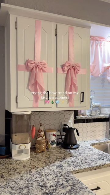 Pink Kitchen Christmas Decor, Christmas Bow On Door, Cabnit Christmas Bow, Bedroom Christmas Decor Pink, Bow Door Christmas, Bows On Cupboards, Bow Door, Girlie Christmas Decor, Pink Christmas House Decorations