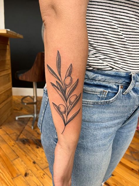 Girl with tattoo Olive Branch Shoulder Tattoos For Women, Snake Olive Branch Tattoo, Green Olive Branch Tattoo, Lettered Olive Shell Tattoo, Neo Traditional Olive Branch, Olive Branch Tattoo Color, Olive Juice Tattoo, Leaf Tattoo Traditional, Olive Branch Leg Tattoo