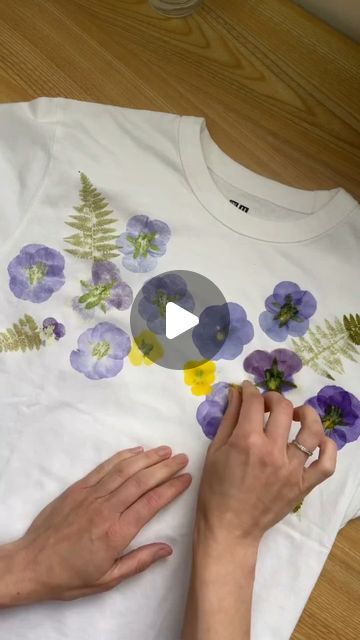 Custom WearHouse on Instagram: "Flower-printed tee 🌸💐 by @hammerflower  . This botanical printing method is achieved by hammering flowers into the fabric! ✨️ What do you think of this technique? . . . . #botanicalart #botanicalprint #flowerpressing #flowerprint #floralprint #floralfashion #floralart #naturaldye #customtees #handprintedtextiles #textileart #tshirtprinting" Flower Printing With Hammer, Tshirt Flowers Print, Flower Hammering On Fabric, Pressed Flowers On Fabric, Hammer Flowers On Fabric, Hammering Flowers On Fabric, Hammered Flowers On Fabric, Pounded Flowers On Fabric, Hammer Flower Art