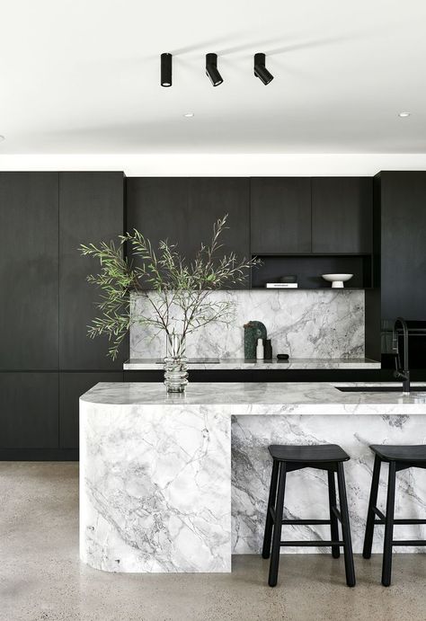 A monochromatic kitchen with a curved stone island, bar stool seating and concrete flooring. Grey Kitchen Decor, Modern Kitchen Design Trends, Monochromatic Kitchen, Monochrome Kitchen, Modern Black Kitchen, St David, Contemporary Barn, Black Kitchen Island, Modern Kitchen Island