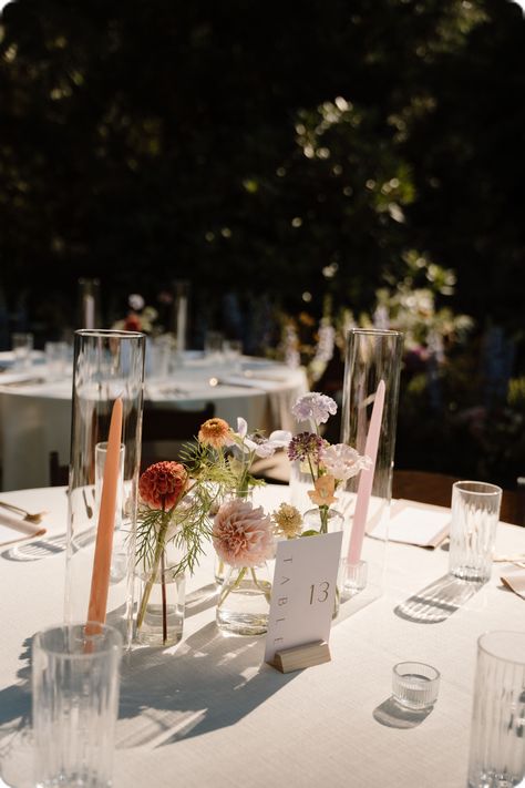 Table Bud Vases Wedding, Centerpieces With Taper Candles, Tiny Vase Centerpiece Wedding, Single Bud Vase Centerpiece Round Table, Garden Style Wedding Florals, Flower Buds Centerpiece, Bud Vases For Wedding Tables, Summer Wildflower Centerpieces, Colorful Bud Vases And Candles