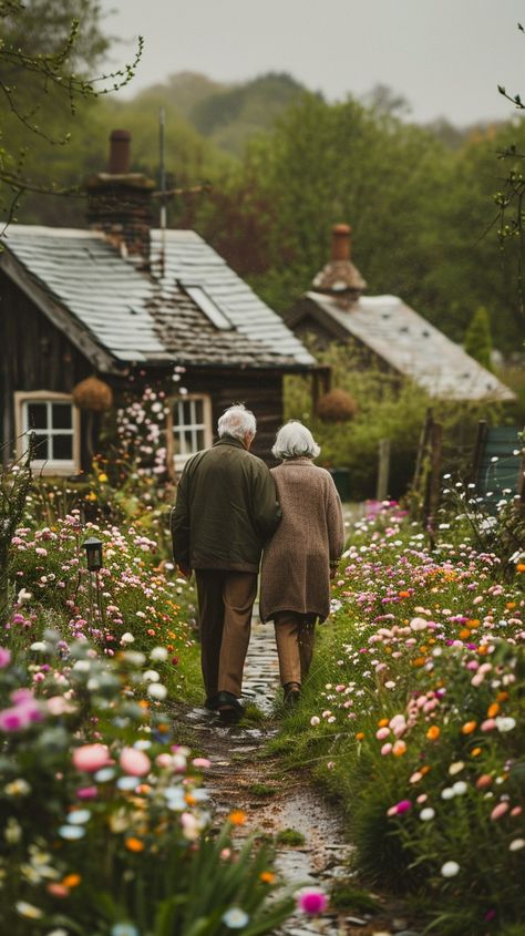 Elderly Couple Walking: An elderly couple takes a leisurely walk together along a flower-lined path near rustic cottages. #elderly #couple #walking #flowers #path #cottages #tranquility #village #aiart #aiphoto #stockcake https://ayr.app/l/pfoq Couple Gardening Together, Adventures For Couples, Couple Walking Photo, Couple Meditating Together, Elderly Aesthetic, Cottage Core Couple, Old Couples In Love, Old Couple Aesthetic, Cottage Couple