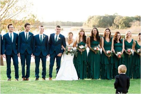 Bridal party and groomsmen, forest green bridesmaid dresses, navy suits Green Suit Green Dress, Navy Suit Emerald Dress, Emerald Green Bridesmaid Dresses And Navy Suits, Dark Green Navy Wedding, Dark Green Bridesmaid And Groomsmen, Green Bridesmaid Dress And Groomsmen, Navy Blue And Green Groomsmen, Navy And Emerald Wedding Party, Emerald Green And Dark Blue Wedding