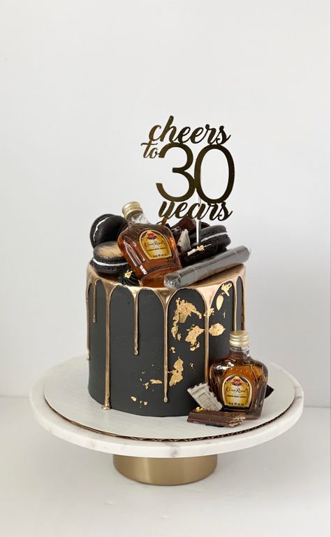 Black cake with gold drip and gold leaf details. On top and on the side there are assorted chocolates and crown royal bottles. There’s a cigar on top of the cake as well as a cake topper that reads “Cheers to 30 years”. Cake For Him Birthday, Man 30th Birthday Ideas, 30th Birthday Party For Him, Cake Black And Gold, Dirty 30 Cake, 30th Birthday Cakes For Men, Black And Gold Birthday Cake, 35th Birthday Cakes, 40th Birthday Cakes For Men