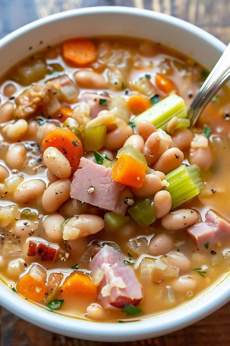 Stay warm this winter with a big bowl of old-fashioned ham and bean soup. It's a hearty, healthy, budget-friendly meal the whole family will love. Ham And 15 Beans Crockpot Recipes, Classic Ham And Bean Soup, Lima Bean Ham Soup, White Bean Ham Soup Crockpot, Leftover Ham Bean Soup, Ham And Great Northern Bean Soup Recipes, Basic Ham And Bean Soup, Ham And Beans Crockpot Recipes Best, Northern White Bean Soup