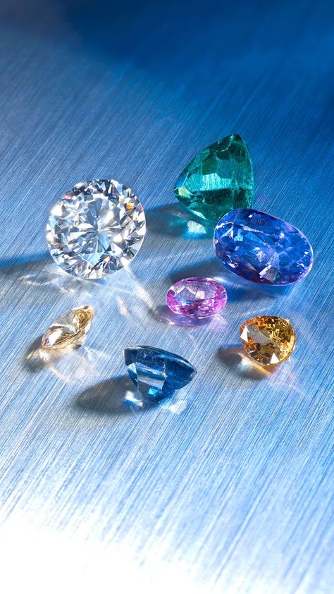 A variety of sapphires, a brilliant-cut diamond and a triangular shape apatite. Gemstones Photography, Gem Wallpaper, Fashion Illustration Tutorial, Rainbow Carrots, Bling Wallpaper, Expensive Jewelry Luxury, Diamond Image, Pretty Backgrounds, Diamond Jewelry Designs