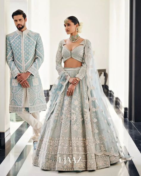 Bride Story on Instagram: “The dreamy icy blue lehenga and sherwani is the ideal assortment of modern elegance and a timeless tale for summertime soirée. All the…” Bride And Groom Indian Wedding Outfit Pastel, Indian Bride Wedding Dress, Day Wedding Outfit Indian, Engagement Lehengas For Bride, Interracial Indian Wedding, Bridal Reception Dress Indian, Indian Wedding Couple Outfits, Engagement Outfits For Bride, Bride And Groom Indian Wedding Outfit