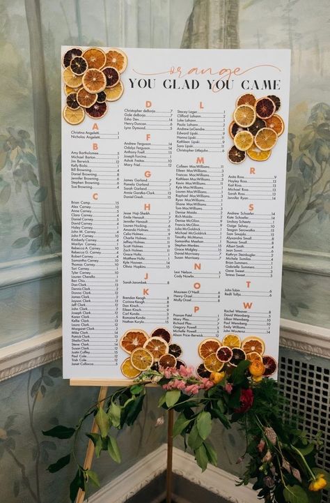 Wedding seating chart that says "Orange You Glad You Came". The seating chart is accented with dried citrus slices and is propped up on a wooden easel. Surrounding the seating chart are beautiful spring flowers. Table Seating Chart, Citrus Wedding, Wedding Reception Decor, Card Table Wedding, Bright Wedding, Orange You Glad, Orange Wedding, Date Cards, Gift Table