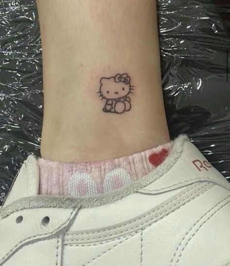 The best way to show your love for hello kitty is to get a tattoo of her! This whimsical character is sure to make a great addition to your body art collection. Cute Small Hello Kitty Tattoos, Cute Hello Kitty Tattoo Ideas, Cute Sanrio Tattoos, Sanrio Tatoos, Tatuajes Hello Kitty Tattoos, Little Cute Tattoos, Sanrio Tattoo Ideas, Small Hello Kitty Tattoo, Tattoo Hello Kitty