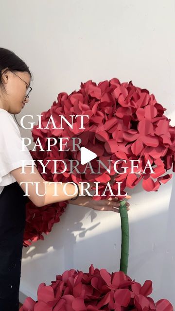 Paper Flowers Malaysia on Instagram: "Materials needed are papers, glue, wire (about 40 cm length), scissors & tape. You need to make about 250 petals to make into a giant hydrangea. Have fun ❤️" How To Make Giant Paper Flowers Diy Video Tutorials, Crepe Paper Flower Centerpieces, Giant Paper Hydrangea Diy, Cricut Giant Paper Flowers, Paper Greenery Diy, Crepe Paper Hydrangea Diy, Diy Hydrangea Flower, Crepe Paper Hydrangea, Hydrangea Paper Flowers Diy