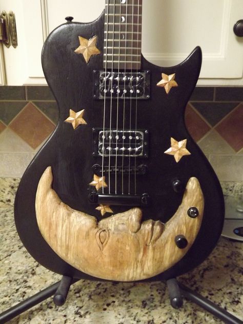 Luna Guitar I carved with a moon and stars motif Cool Ukulele Designs, Painted Guitar Picks Diy, Pretty Electric Guitar, Cool Electric Guitar Design, Painted Guitars Ideas, Art On Guitar, Guitar Decor Ideas, Guitar Design Art, Cool Guitar Designs