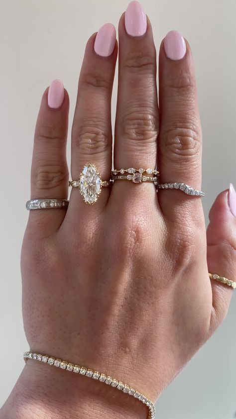 Inspired by our Odessi, just scaled down in width, the Odette showcases an intricate vintage inspired design that runs all the way around a her band with white diamonds set within the features of the band. This desired design is the perfect combination of vintage chic and glamour. Drop-down diamond options represent our recommended grade, which maximizes size for value, while maintaining eye-perfect clarity and giving you a colorless look. For other diamond options, see our Shop Diamonds tab or Princess Ring Stack, Rings Engagement Marquise Bridal Sets, Stacked Wedding Bands With Halo Ring, Old Mine Moval Cut Engagement Ring, Rare Engagement Ring, Marquise Ring And Band, Big Vintage Rings, Yellow Marquise Engagement Ring, 3 Carat Marquise Diamond Ring