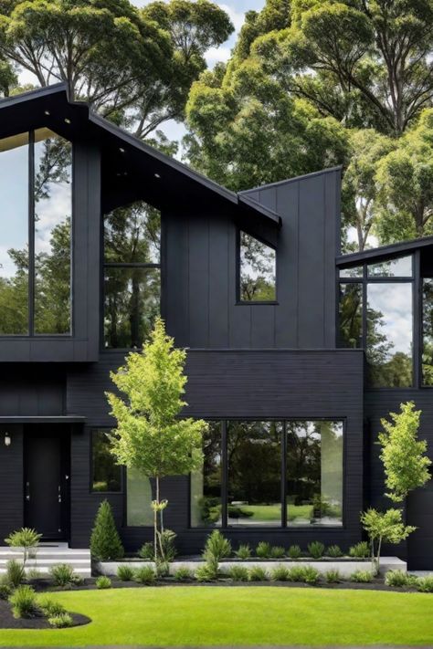 Modern black house with large windows, surrounded by lush greenery and trees. Tiny Modern House Exterior, Modern House Black Windows, Black Roof Tan House, Dark House Landscaping, Black Modern Windows, Modern Black Exterior House, Charcoal Home Exterior, Black And Wood House Exterior, Black Contemporary House