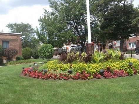 Landscape Design to Highlight a Flagpole | KG Landscape Management Flag Pole Landscaping, Flagpole Landscaping Ideas, Small Retaining Wall, Tall Shrubs, Residential Landscaping, Perennial Shrubs, Moon Garden, A Flag, Landscape Features