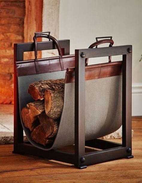 A sturdy iron frame and canvas-and-leather sling on Pottery Barn';s Industrial log carrier/holder make it both handsome and functional | archdigest.com Industrial Fireplace, Indoor Firewood Rack, Firewood Storage Indoor, Log Carrier, Classic Fireplace, Firewood Holder, Industrial Inspiration, Fireplace Logs, Small Fireplace