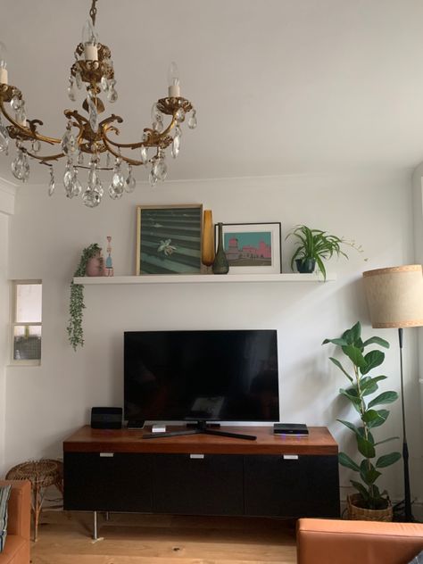 Styling a shelf above your TV @no5_blackfriars House plants Tv Room Shelf Decor, Shelf About Tv, Decor Above Tv Stand Living Rooms, Mounted Tv Styling, Tv On A Shelf, Living Room Tv Shelf Decor, Plants Around Tv Stand, Shelf Above Tv On Wall, Shelves Above Tv Decor