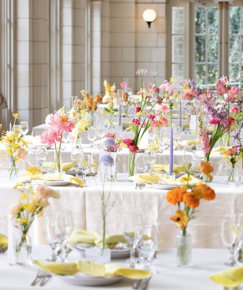 These colors are a dream 😍 This color palette is perfect for a romantic and whimsical summer wedding. Get creative when adding color to your tablescape including the candles, glassware and napkins to compliment these gorgeous arrangements. #Alinato #AlinatoEvents #WeddingInspo #WeddingTablescapes #weddingtable #weddingseason #weddingplanning #weddingtrends #tables #weddingdecor #decor #weddinginspiration #weddingphotography #weddings #nycweddings #wedding #theknot #vogueweddings #brides White Wedding Pops Of Color, Colorful Glass Wedding, Wedding Centerpieces Diy Circle Table, Minimalist Spring Wedding Decor, Bright Minimalist Wedding, Wildflower Minimalist Wedding, Bridal Color Palette Summer, Colorful Taper Candles Wedding, Circle Table Wedding Decor Colorful