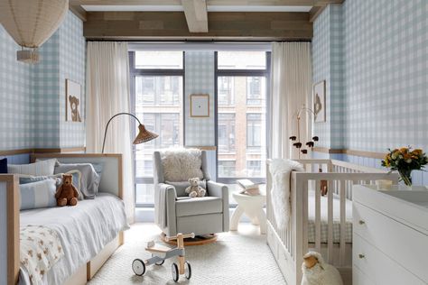 Glider rocker in front of large windows between daybed and crib in nursery with blue and white gingham walls. Crib And Daybed In One Room, Nyc Nursery, Nursery Daybed, Preppy Baby, Dreamy Nursery, Changing Table Dresser, Unisex Nursery, Glider Rocker, Playful Decor