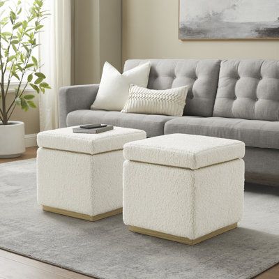 Comfort and convenience all in one - this storage ottoman lets you prop up your feet after a long day, while storing your living room essentials. Crafted from a blend of solid and engineered wood, it features a cubic shape with clean lines and a block base. We love that it's wrapped in foam and upholstered with plush 100% polyester boucle fabric for a touch of texture and a contemporary look. Plus, the cushioned lid lifts off to reveal hidden storage for extra blankets or board games. Our favori Square Ottoman With Storage, Storage Ottoman Square, Cube Storage Ottoman, Ottoman Ideas, Ottoman White, Storage Cube Ottoman, Square Storage Ottoman, Square Storage, Living Room Essentials