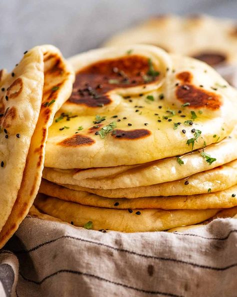 Naan | Recipe Tin Eats ~ Easy recipe for this iconic Indian flat bread; uses instant yeast, either butter or ghee (link given to make ghee), & the dough doesn't require kneading. Fluffy with a chewy, restaurant quality. Brush with garlic-infused ghee or melted butter. Can sprinkle with chopped cilantro & optional nigella seeds. Bread With Garlic, Make Naan Bread, Pizza Naan, Pane Naan, Naan Bread Recipe, Homemade Naan Bread, Homemade Garlic Butter, Pita Bread Recipe, Recipes With Naan Bread